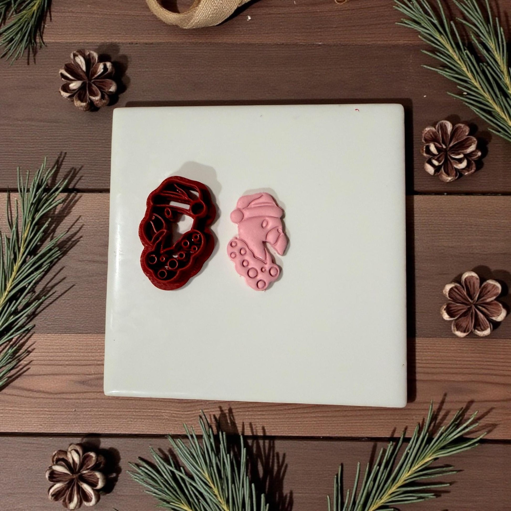 Flamingo cutter and pink clay impression side by side on tile