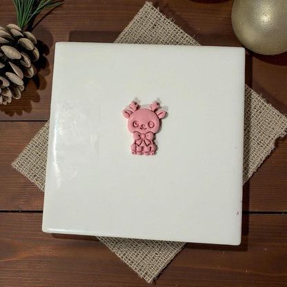 pink reindeer clay piece centered on tile