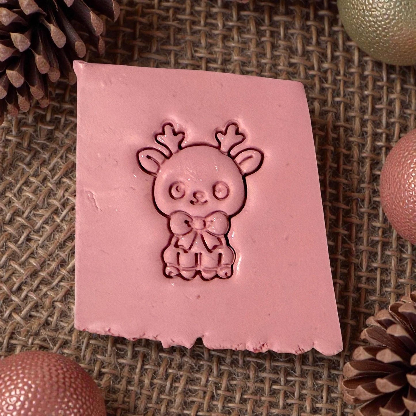 reindeer clay impression pressed into pink clay sheet