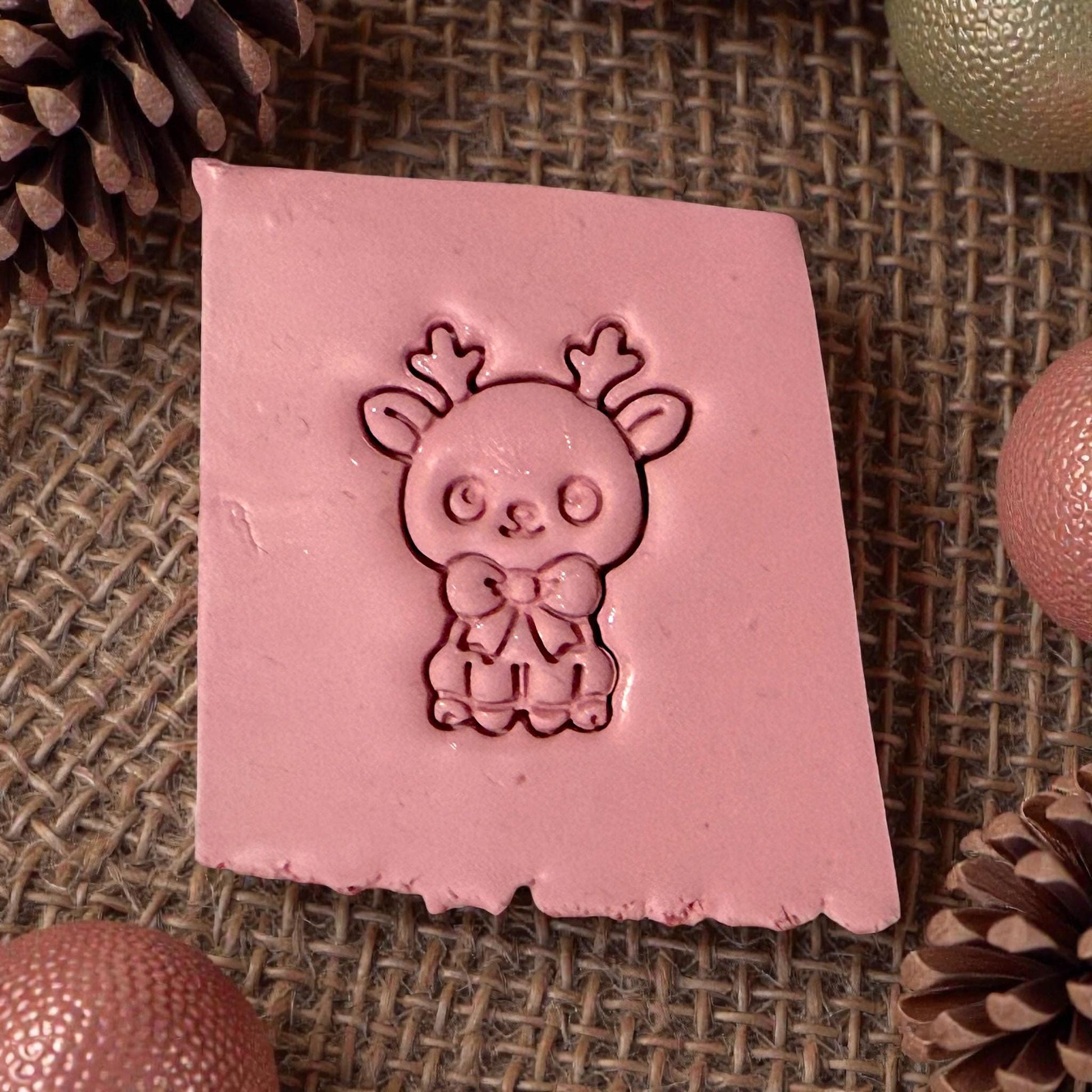 reindeer clay impression pressed into pink clay sheet