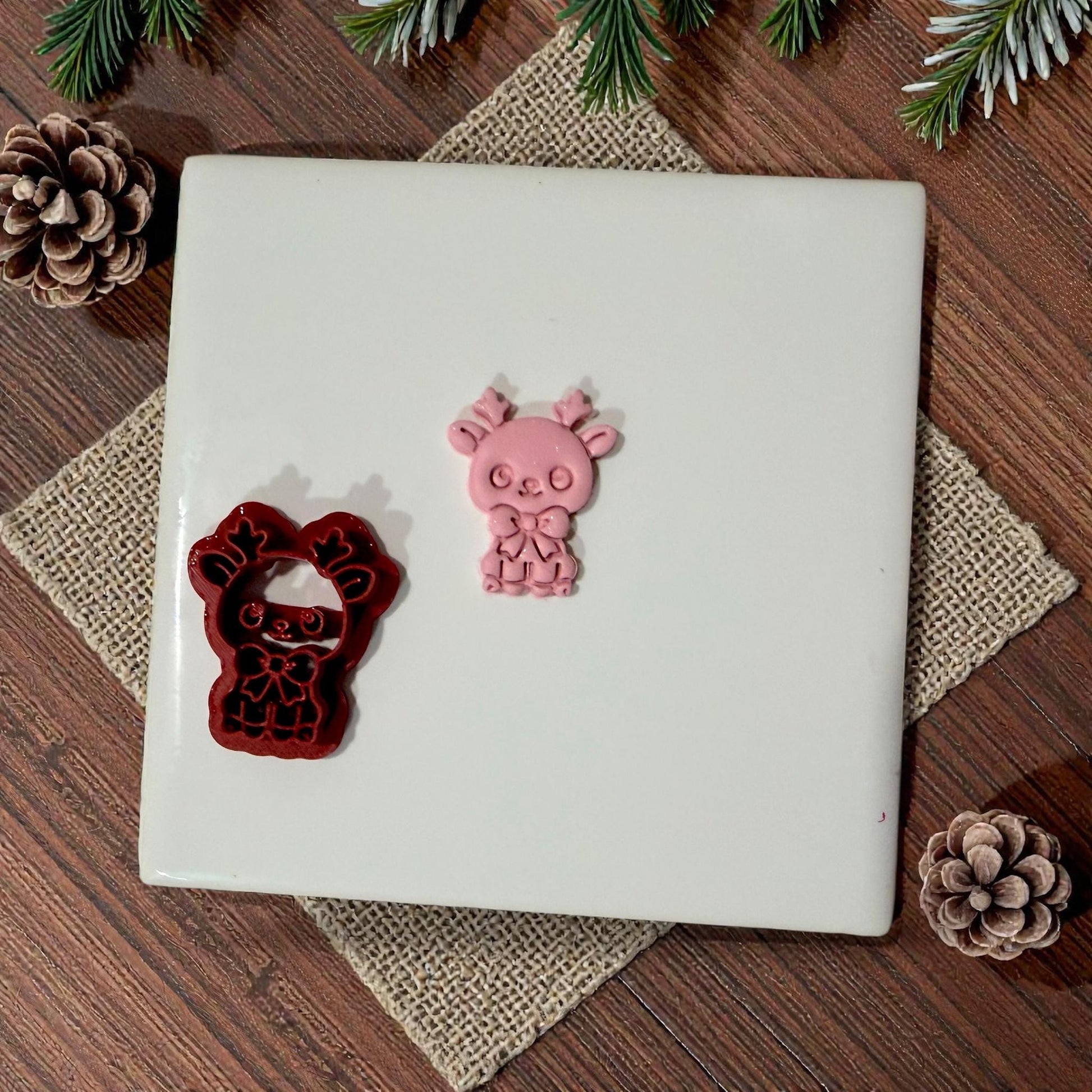 reindeer cutter and clay piece displayed on white tile