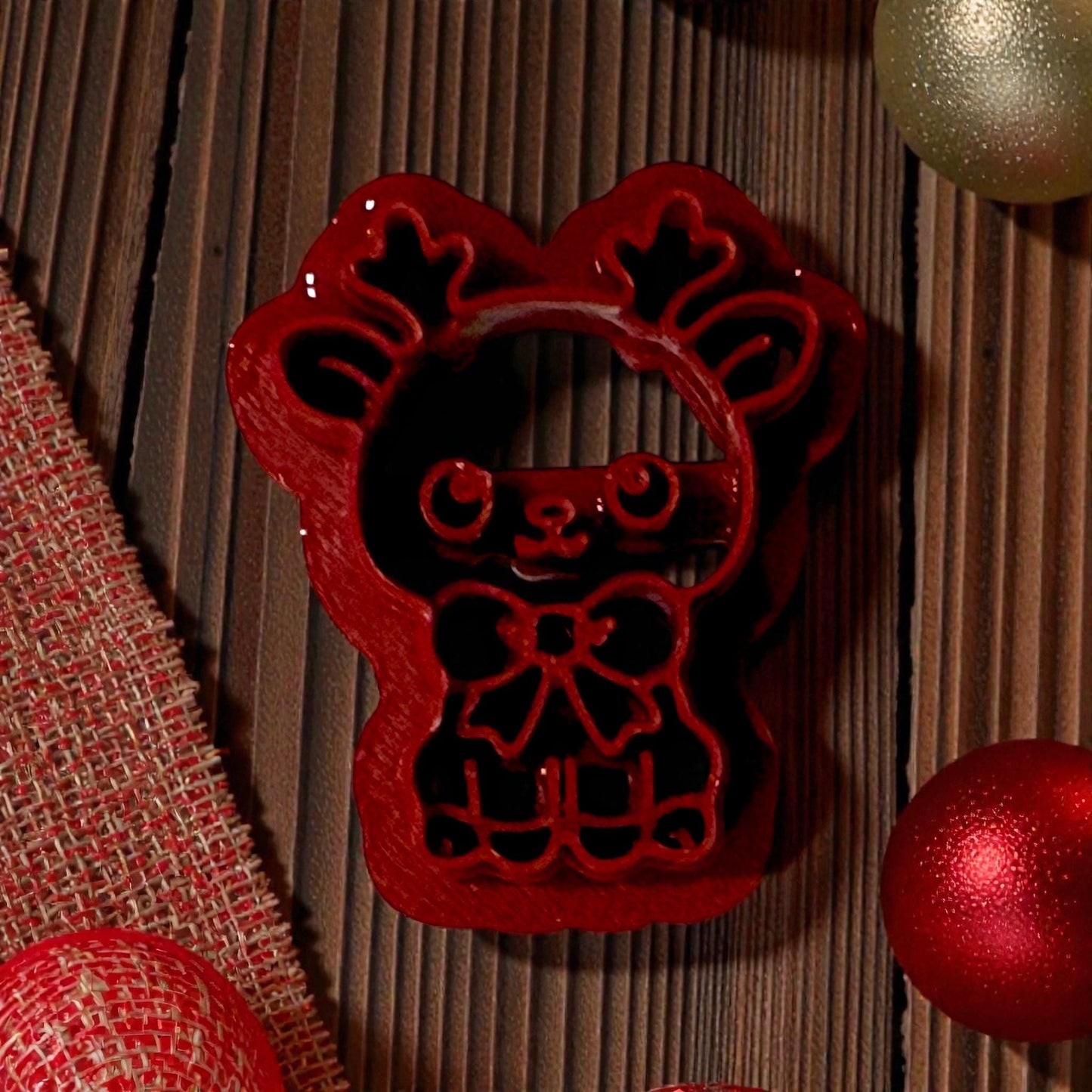 close up red reindeer clay cutter on wood