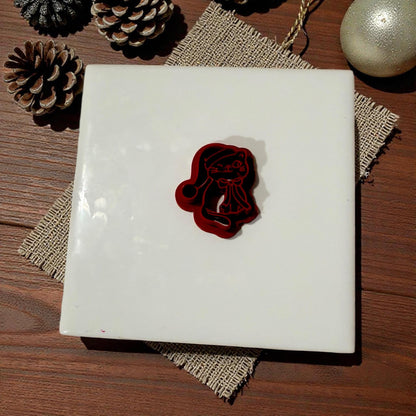 Small cat cutter displayed on white ceramic tile