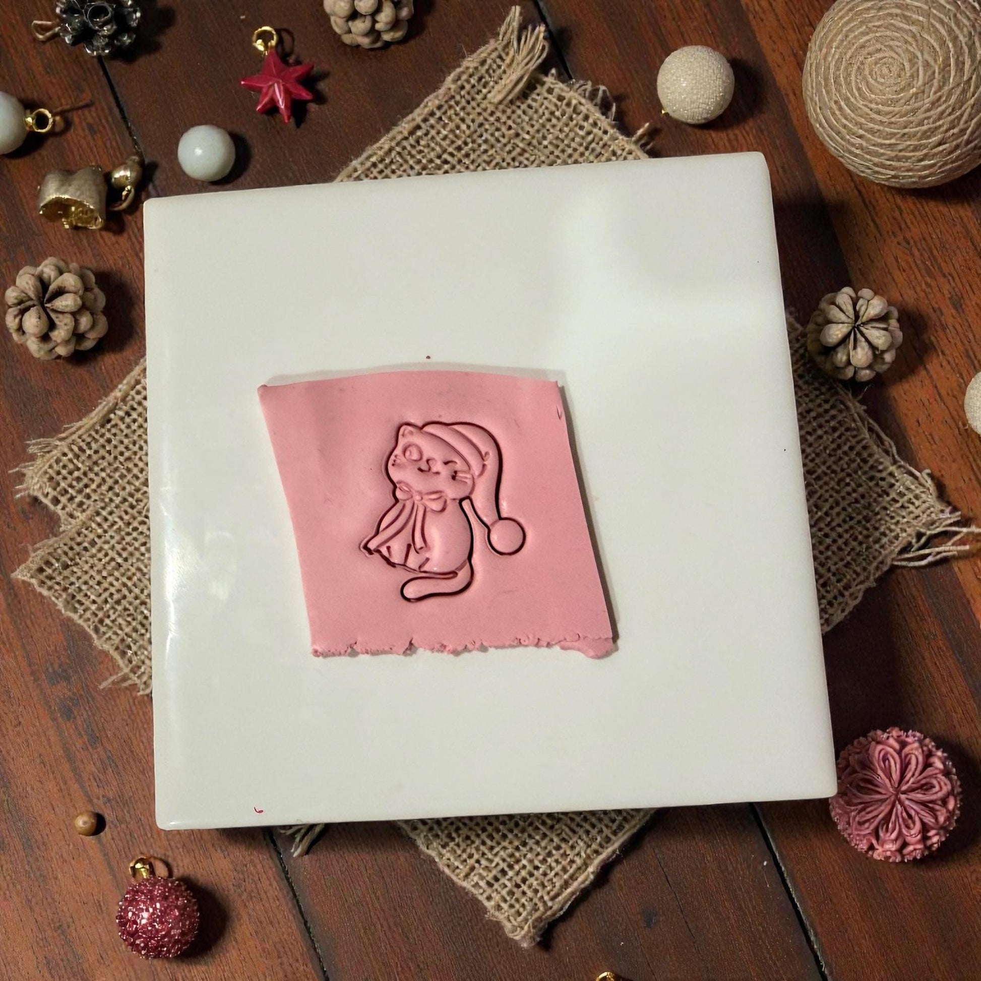 Clay slab impression of Santa hat kitty design