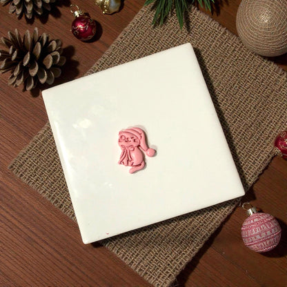 Pink kitty clay shape centered on white tile