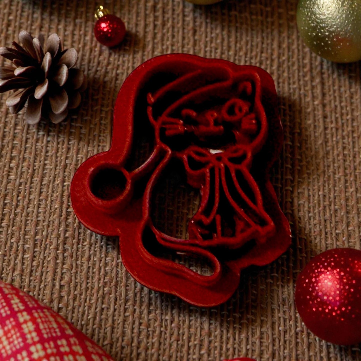 Santa hat kitty polymer clay cutter on textured background