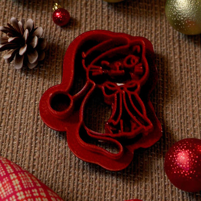 Santa hat kitty polymer clay cutter on textured background