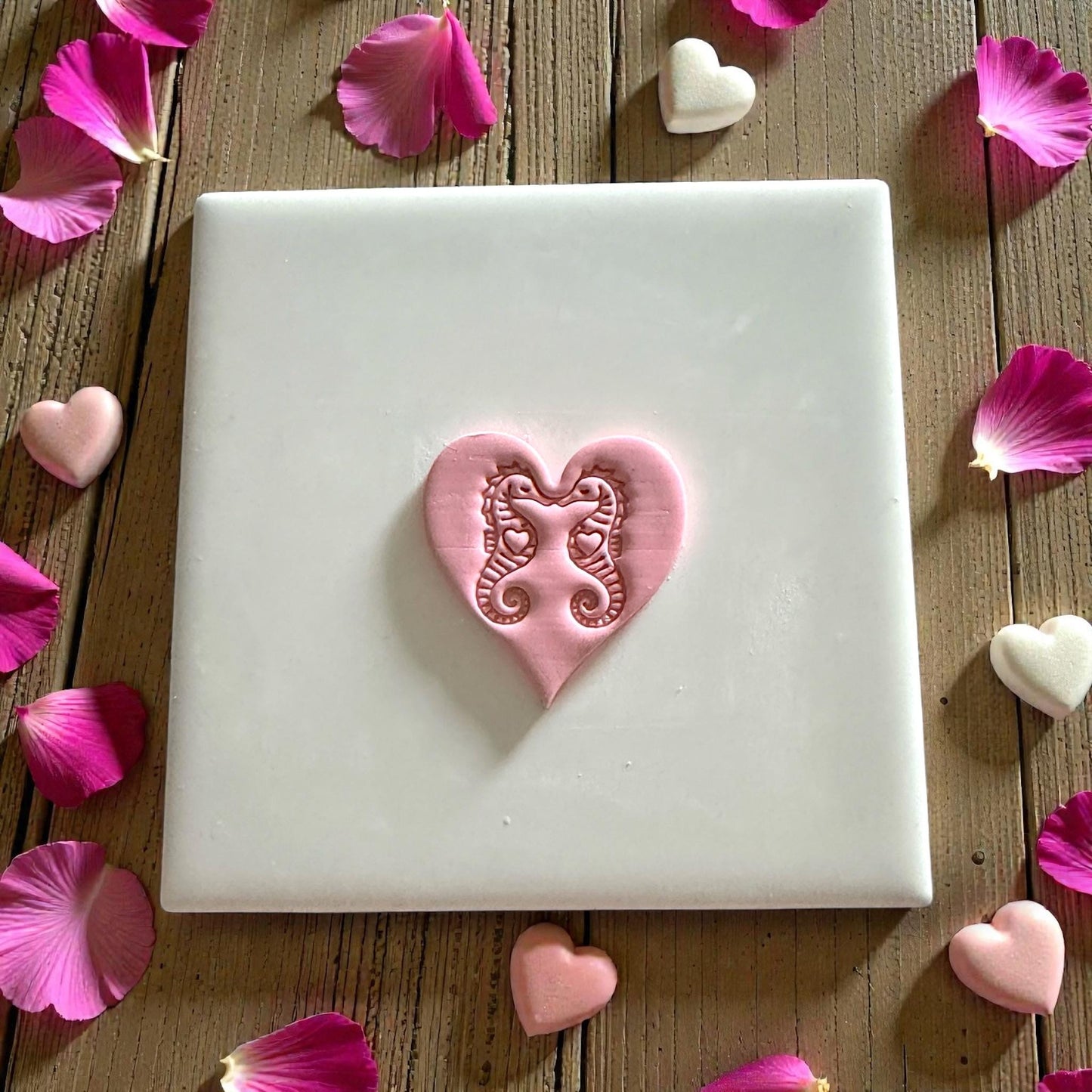 pink seahorse heart clay piece surrounded by petals