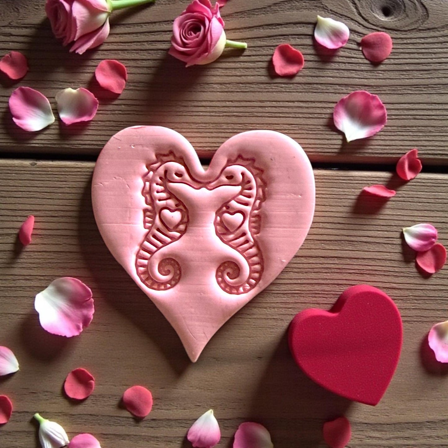 closeup seahorse heart clay design with pink petals