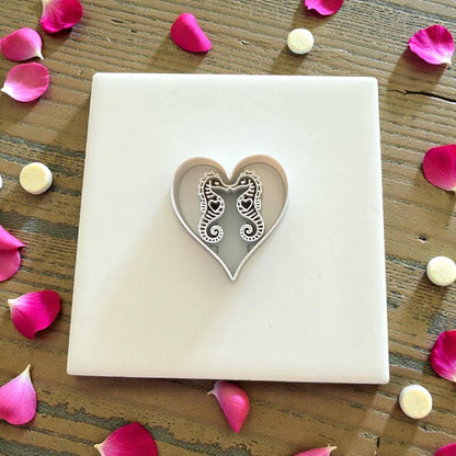 white heart cutter with seahorse details displayed on tile