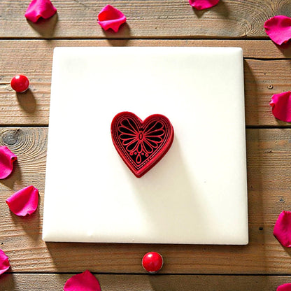 Boho heart cutter sitting on white tile with scattered petals