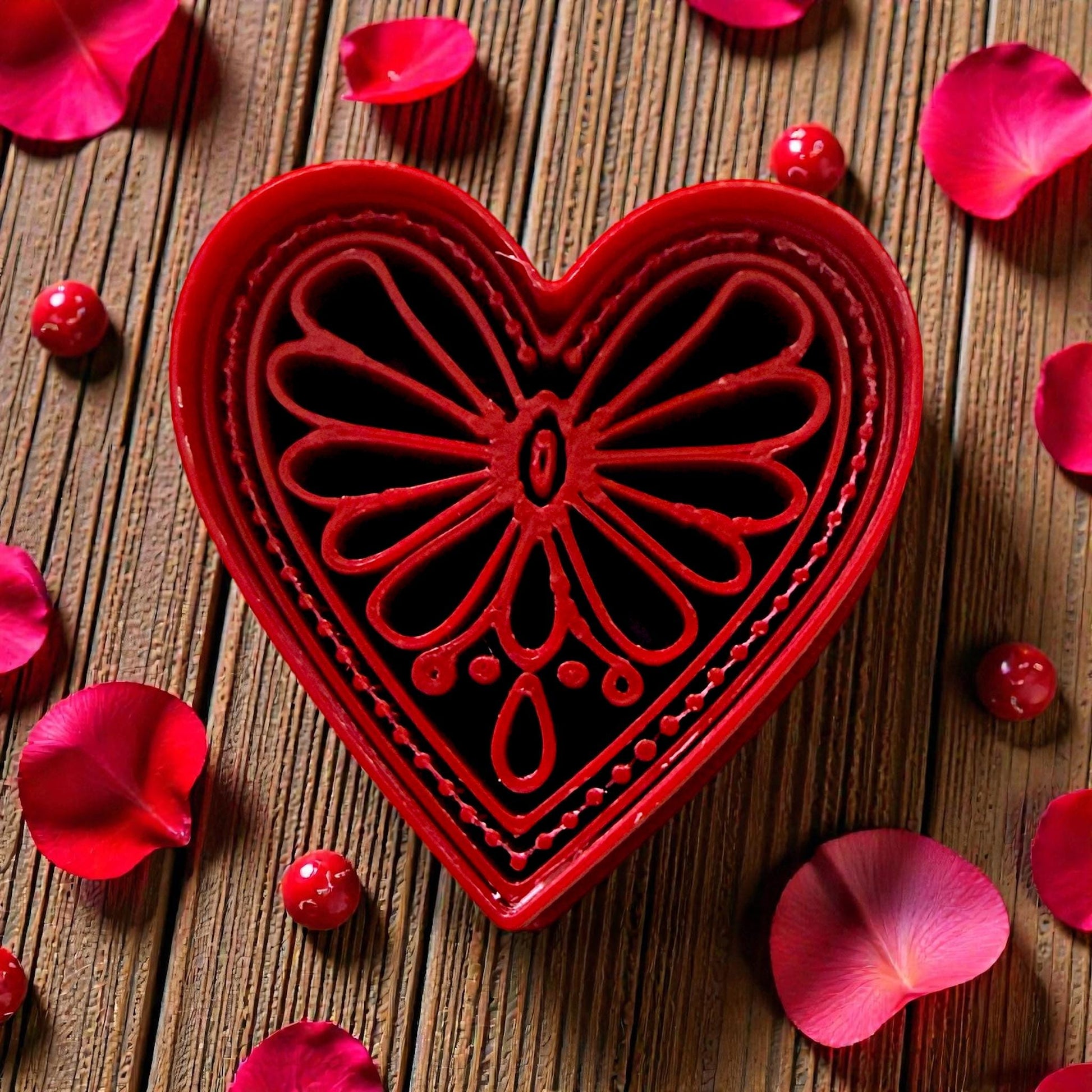 Closeup of red boho heart cutter showing intricate floral pattern