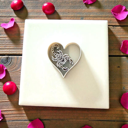 heart scorpion cutter centered on white tile