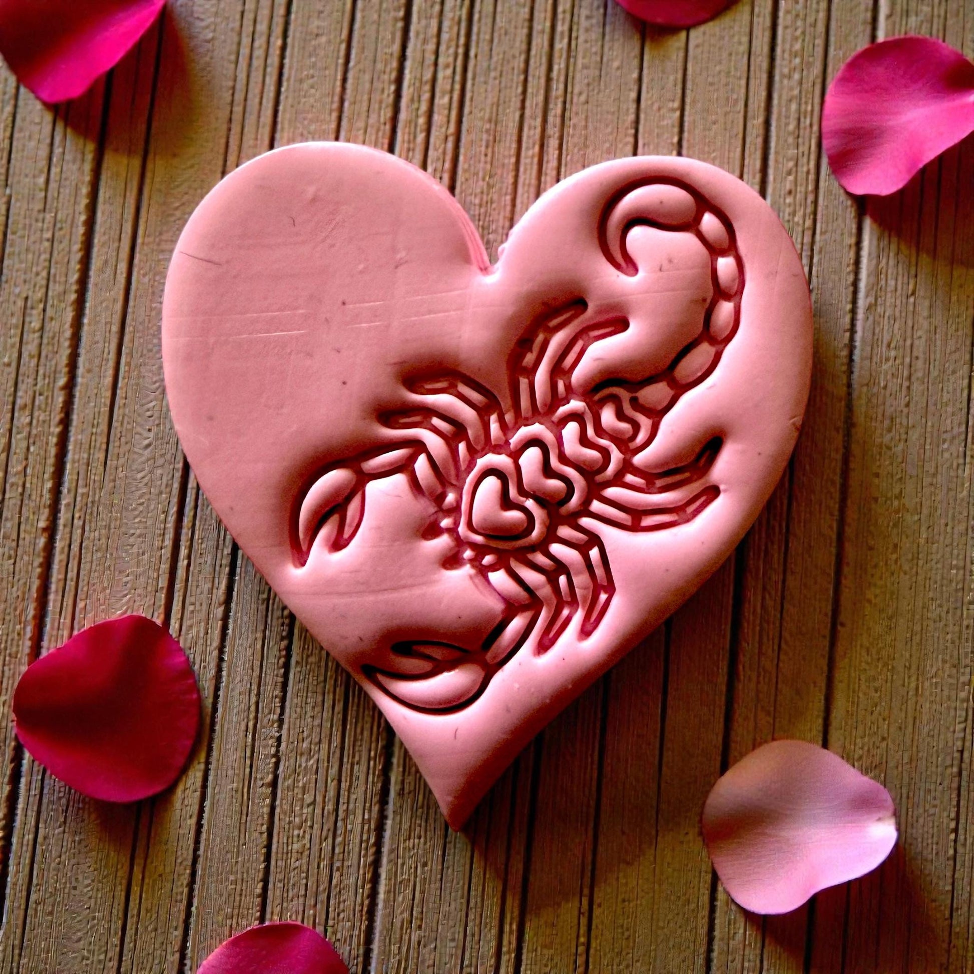 closeup pink heart clay with scorpion motif