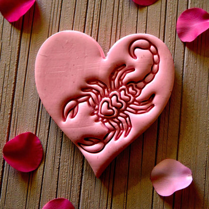 closeup pink heart clay with scorpion motif