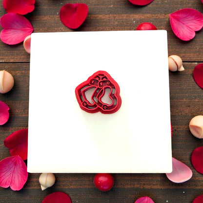 Red handcuff cutter and pink clay hearts