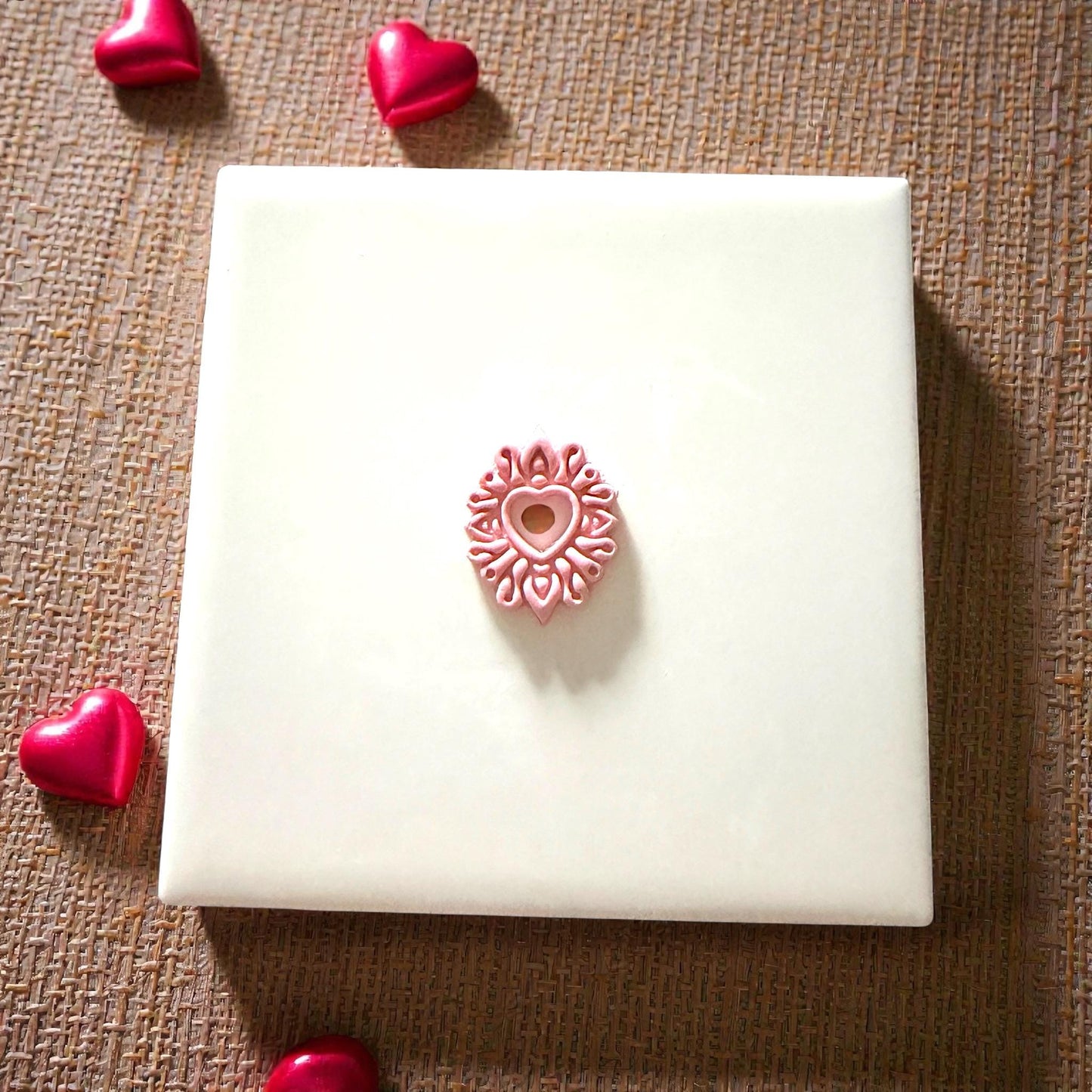 heart mandala clay piece on tile with hearts