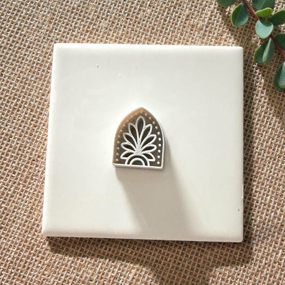 small boho arch clay cutter on white tile