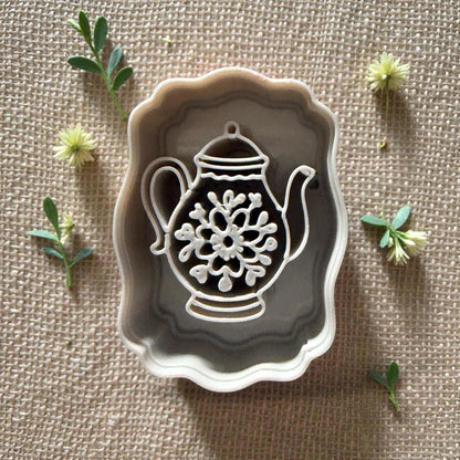 teapot clay cutter with floral center inside scalloped frame