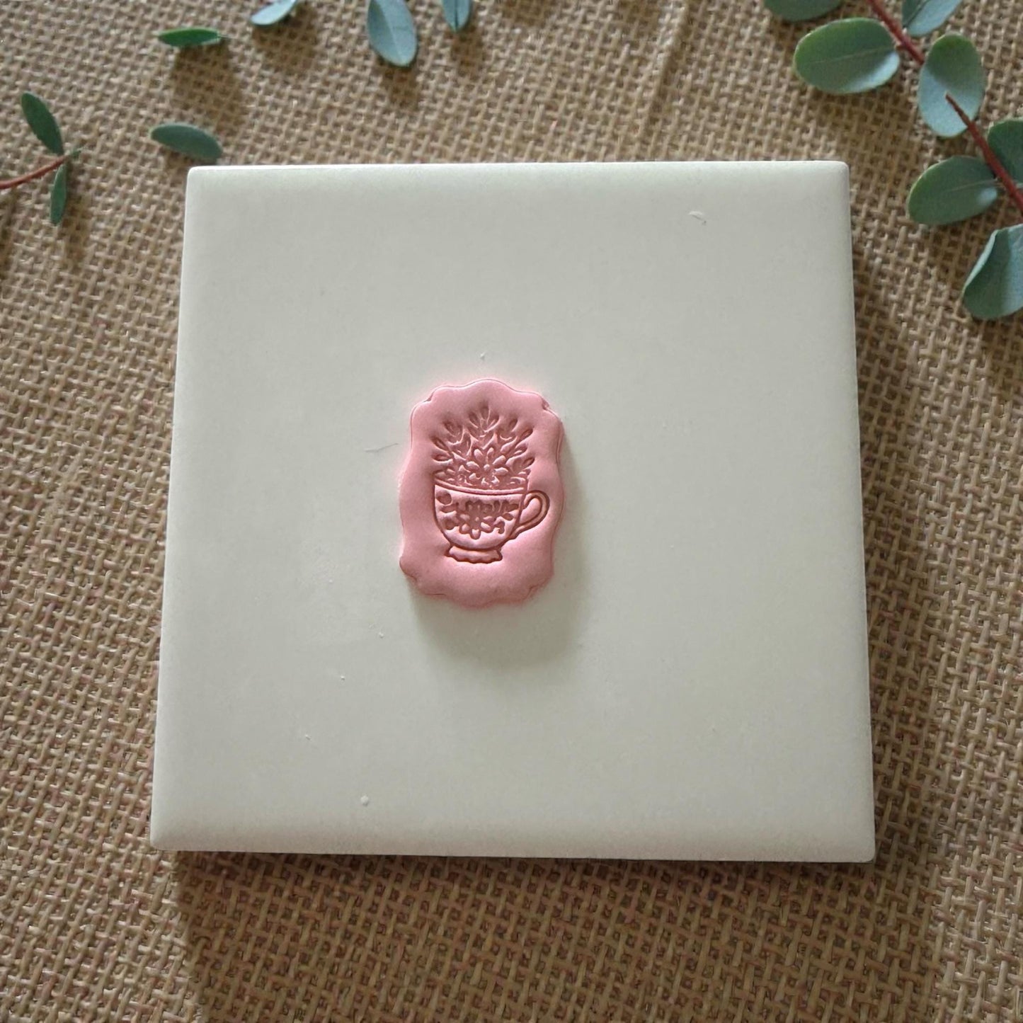 small floral teacup clay impression on white tile