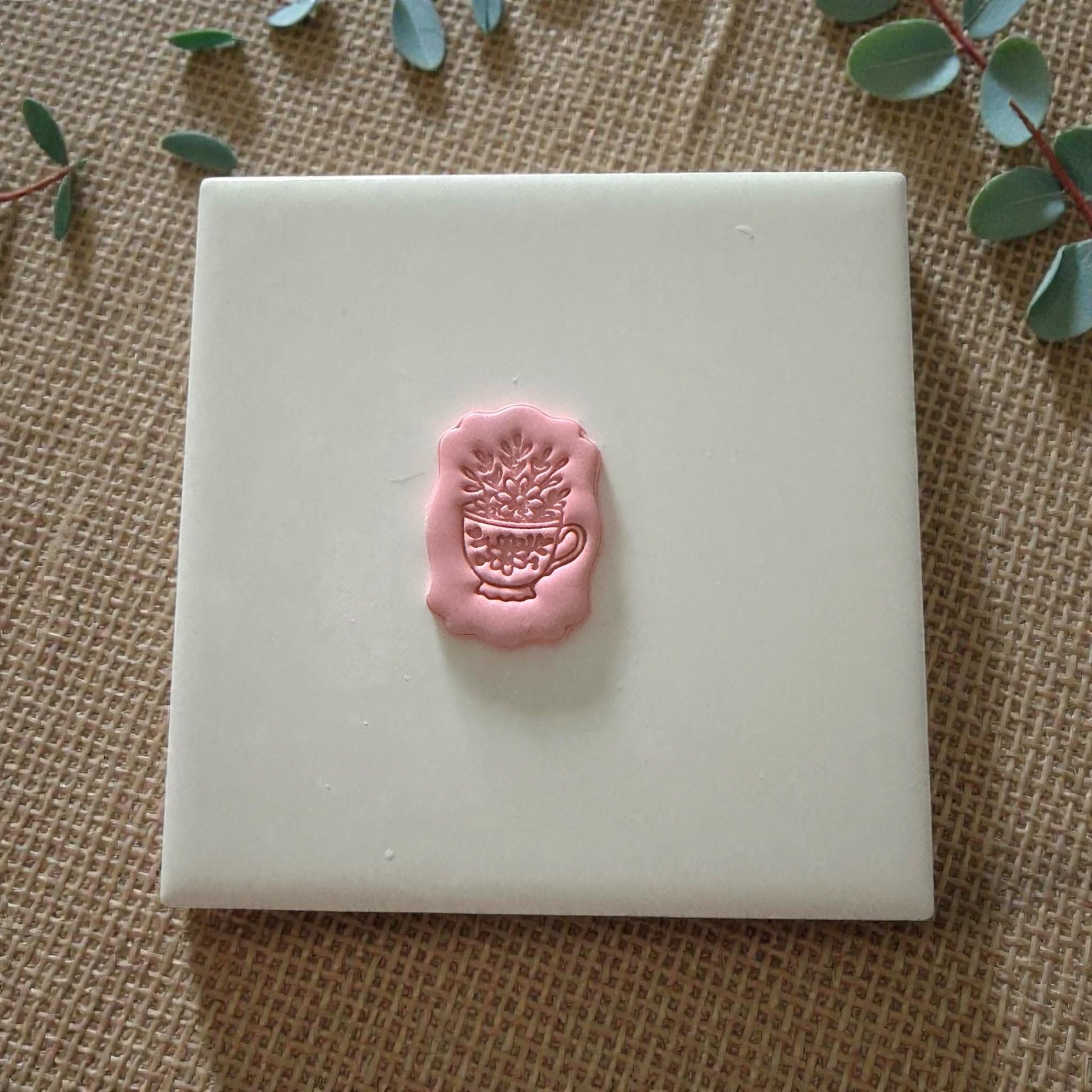 small floral teacup clay impression on white tile