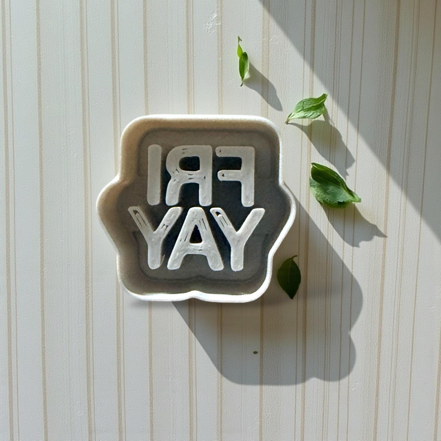 FRIYAY polymer clay cutter shown on striped backdrop