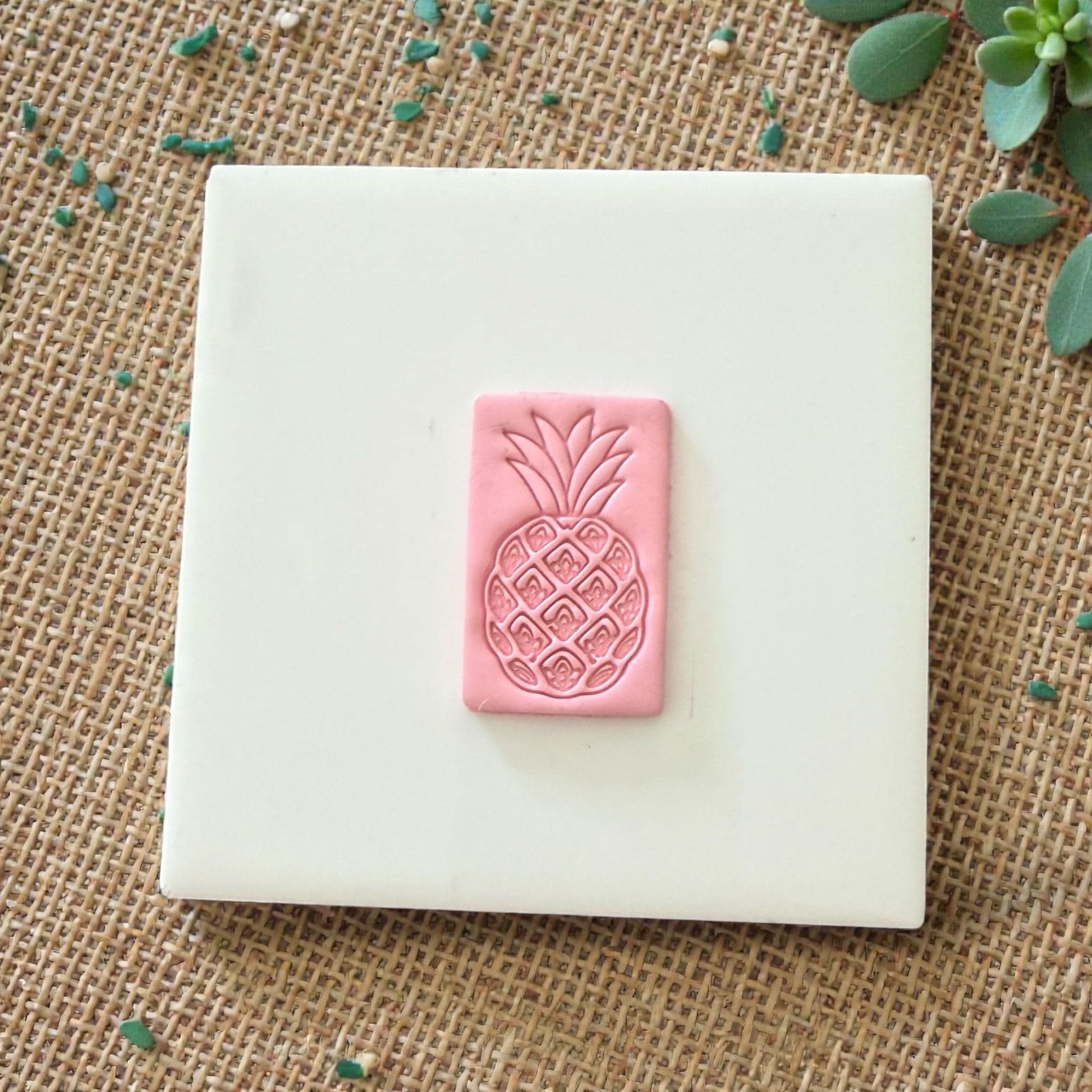 pink pineapple clay impression on white tile