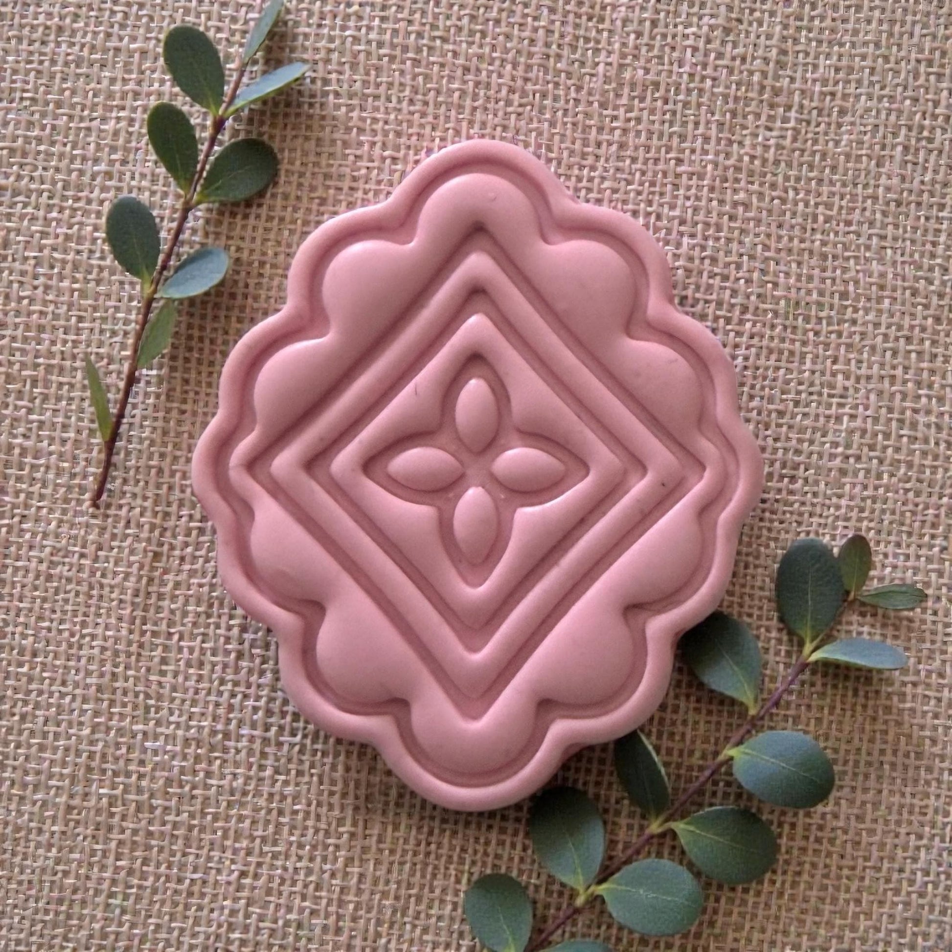 large pink scalloped tile clay impression with greenery