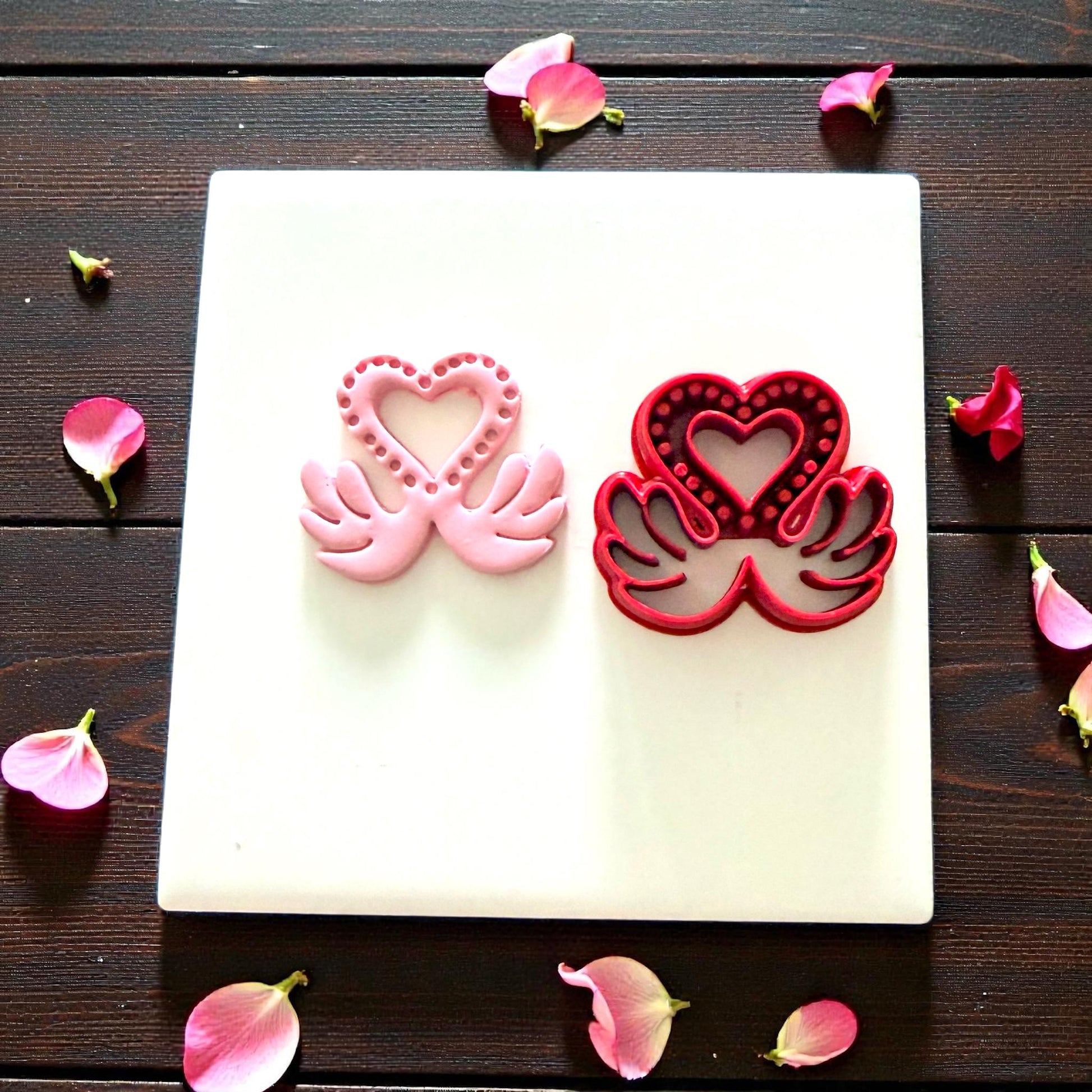 pink and red love swan cutters displayed on white tile