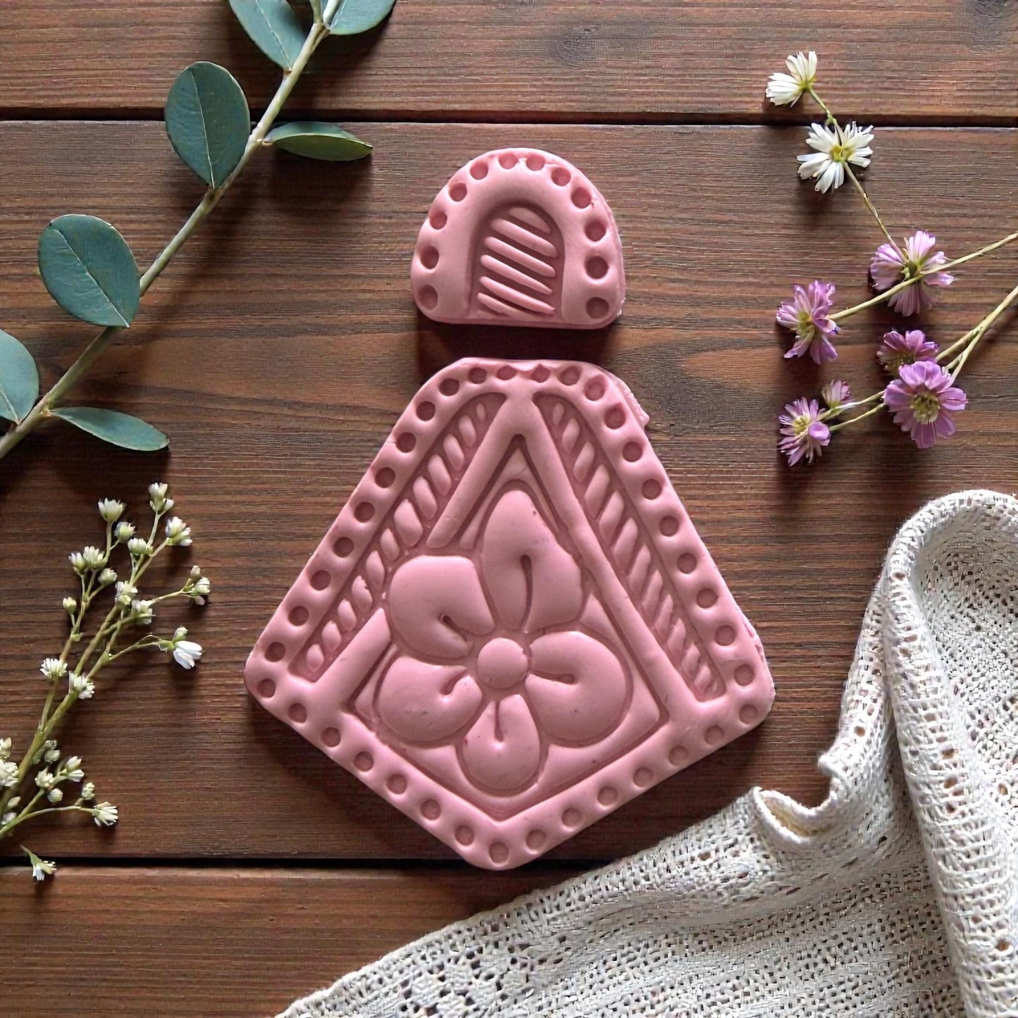 finished floral clay piece displayed on wood