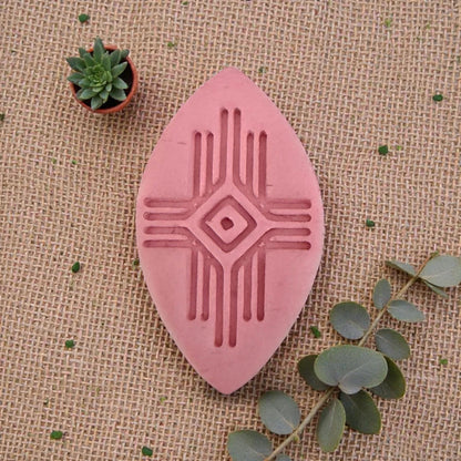 large pink geometric clay imprint on burlap