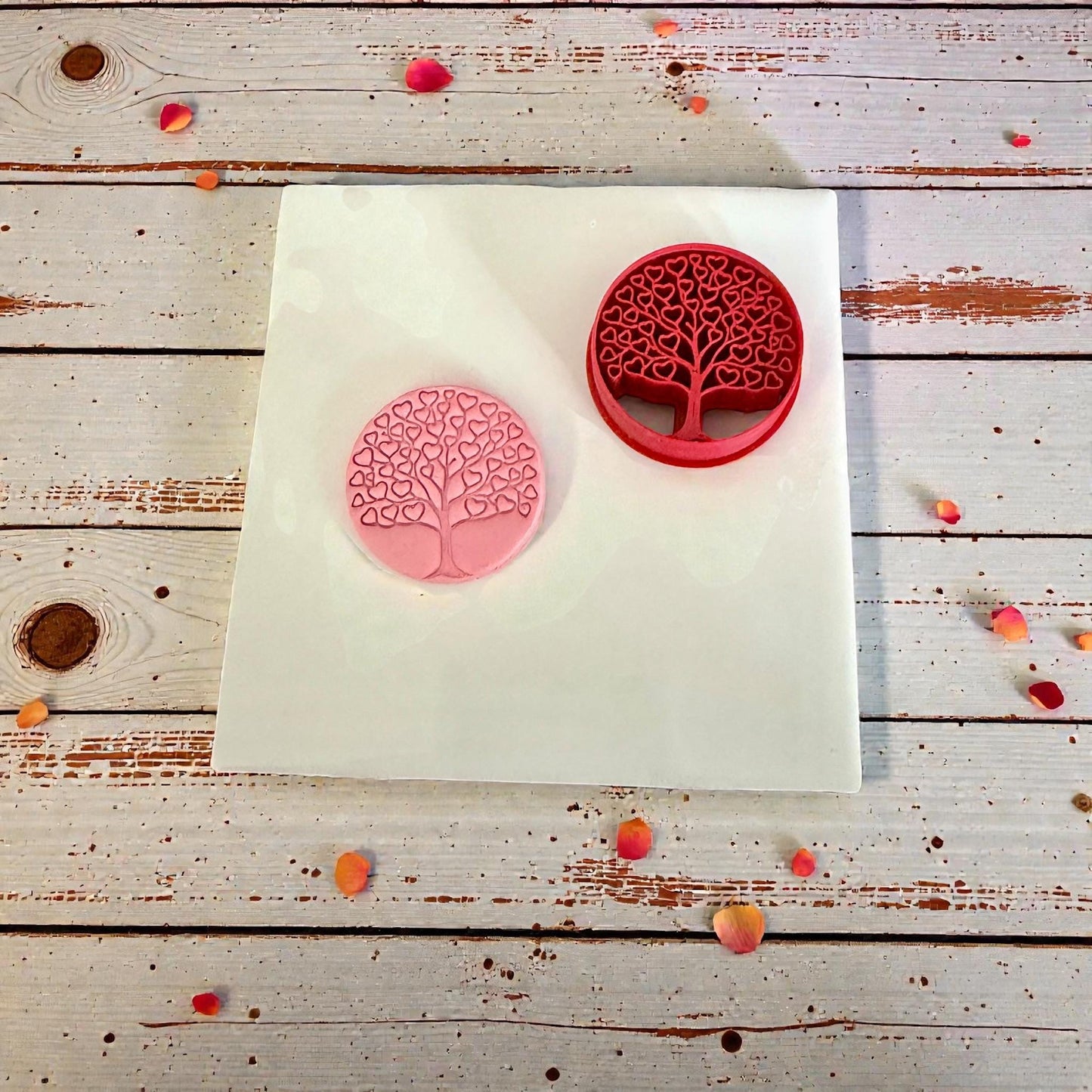 heart tree cutter and pink clay impression on wood