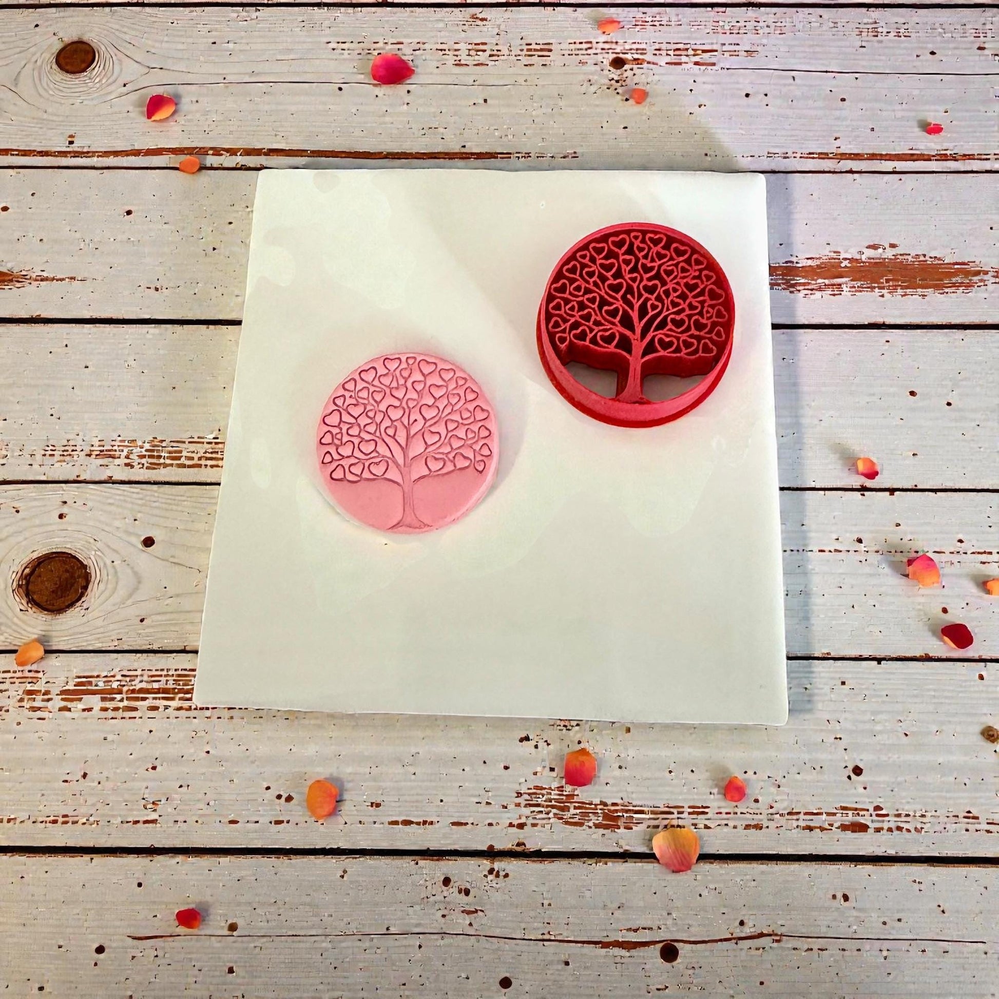 heart tree cutter and pink clay impression on wood