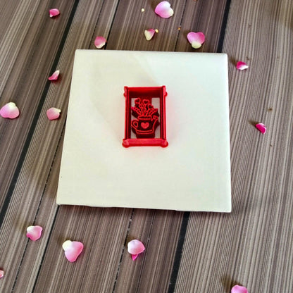 watering can floral heart polymer clay cutter on white tile