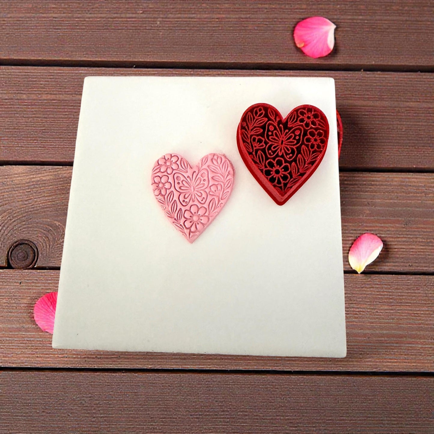 floral heart clay impression next to red cutter