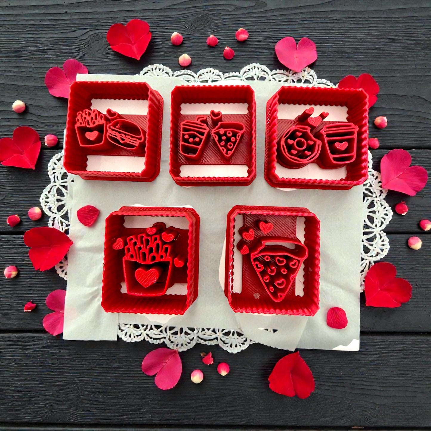 Five red square Valentine food polymer clay cutters with hearts on dark background
