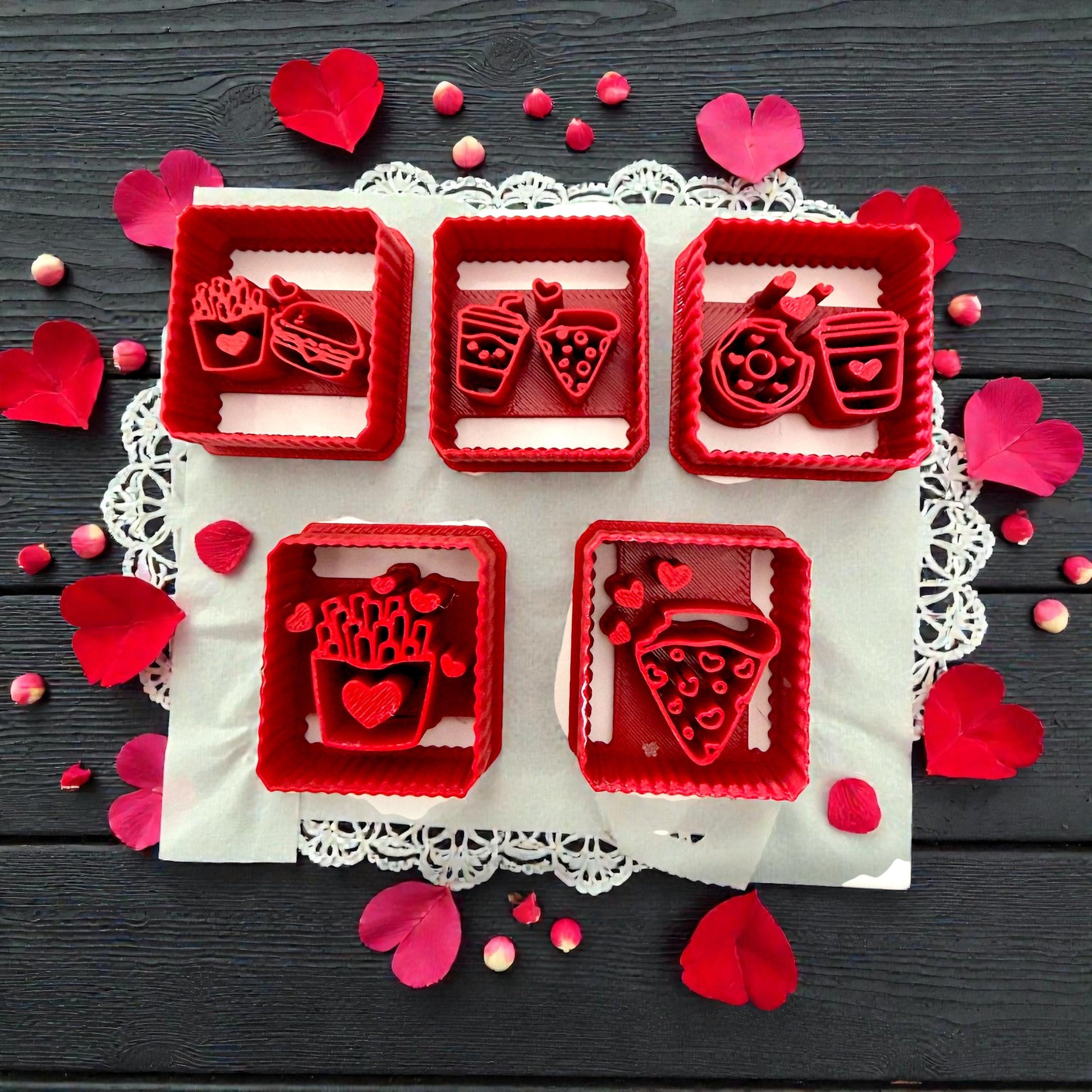 Five red square Valentine food polymer clay cutters with hearts on dark background