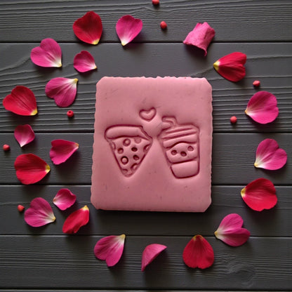 Pink up close pink slab of pizza and drink