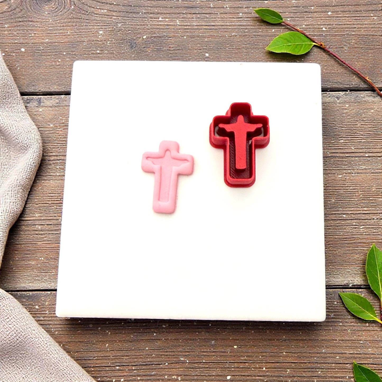 red cross cutter beside clay impression