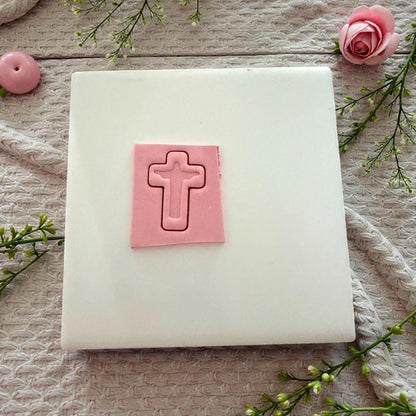pink clay cross imprint on tile