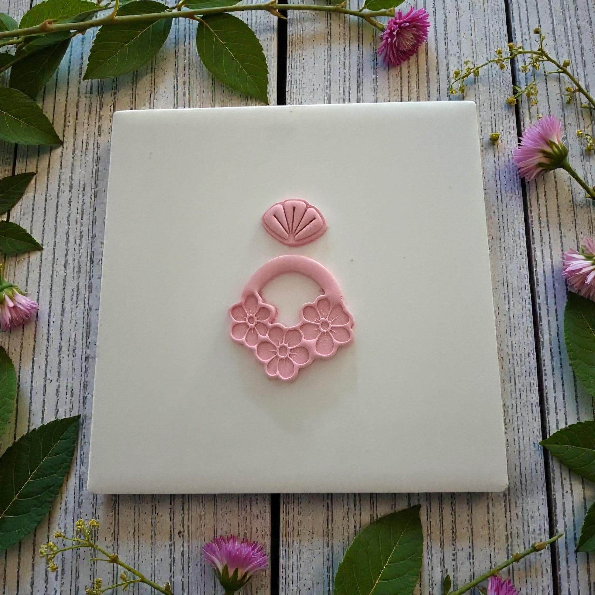clay impression centered on white tile