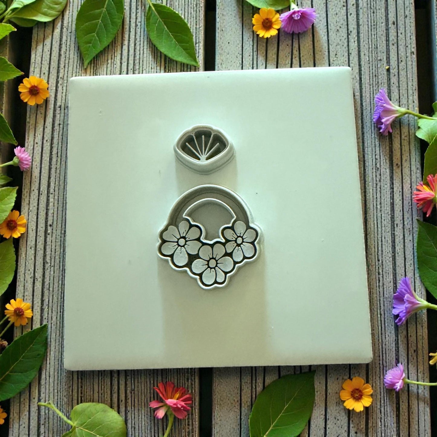 floral clay cutter set displayed on white tile