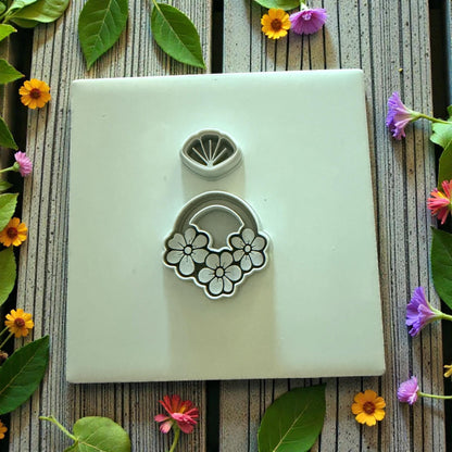 floral clay cutter set displayed on white tile