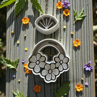 two part floral clay cutter set with flowers on wood