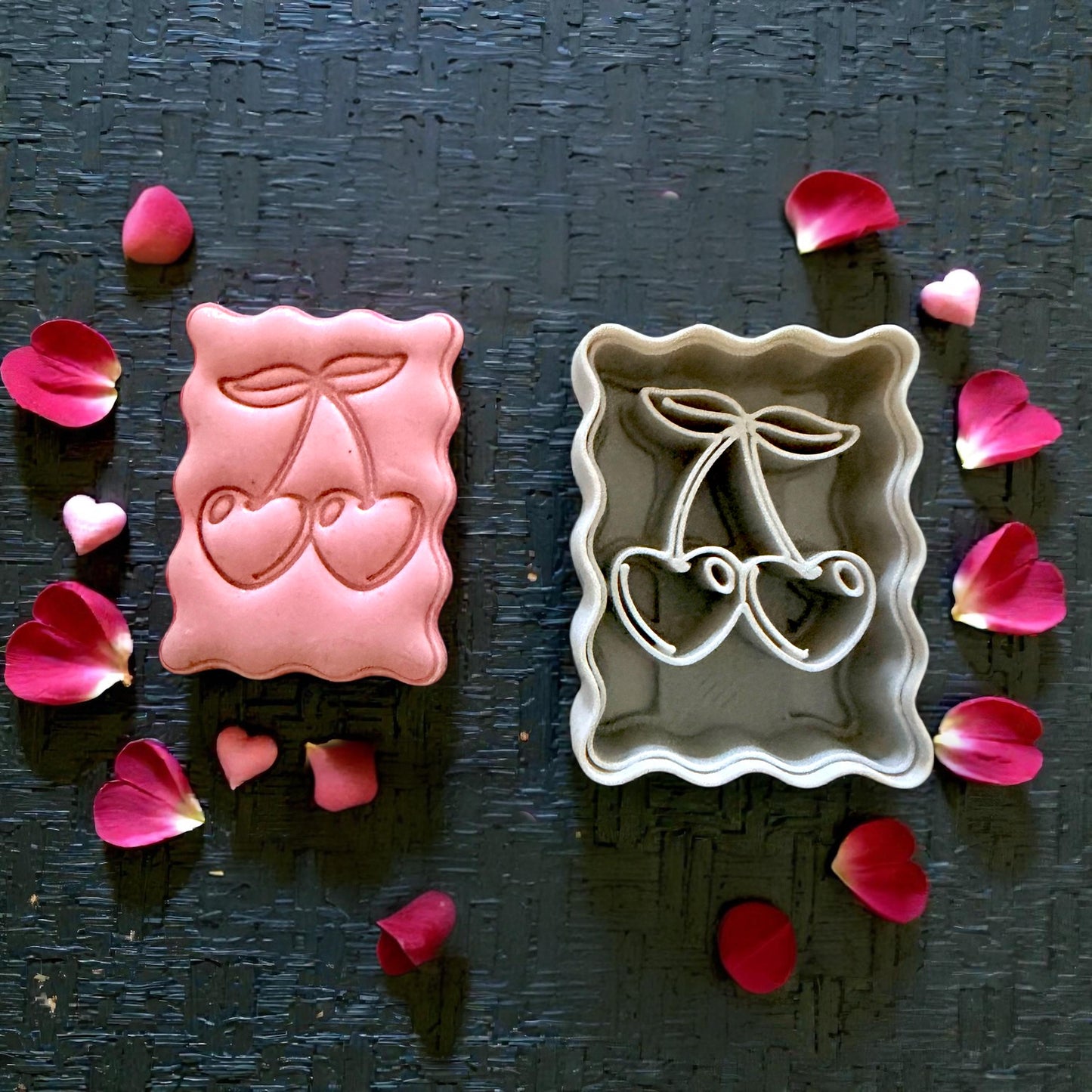 cherry clay impression and cutter flatlay with petals