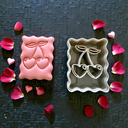 cherry clay impression and cutter flatlay with petals