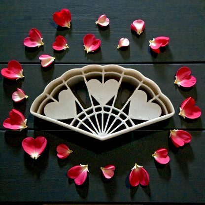 large romantic heart fan cutter surrounded by rose petals