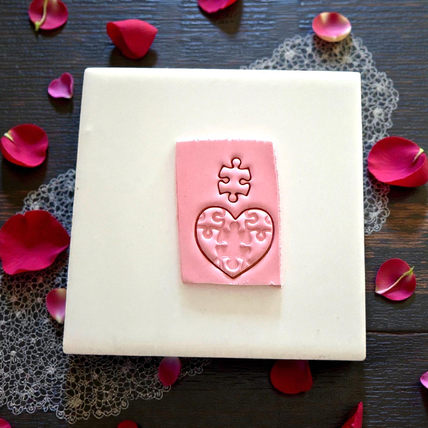puzzle heart clay impression on white tile