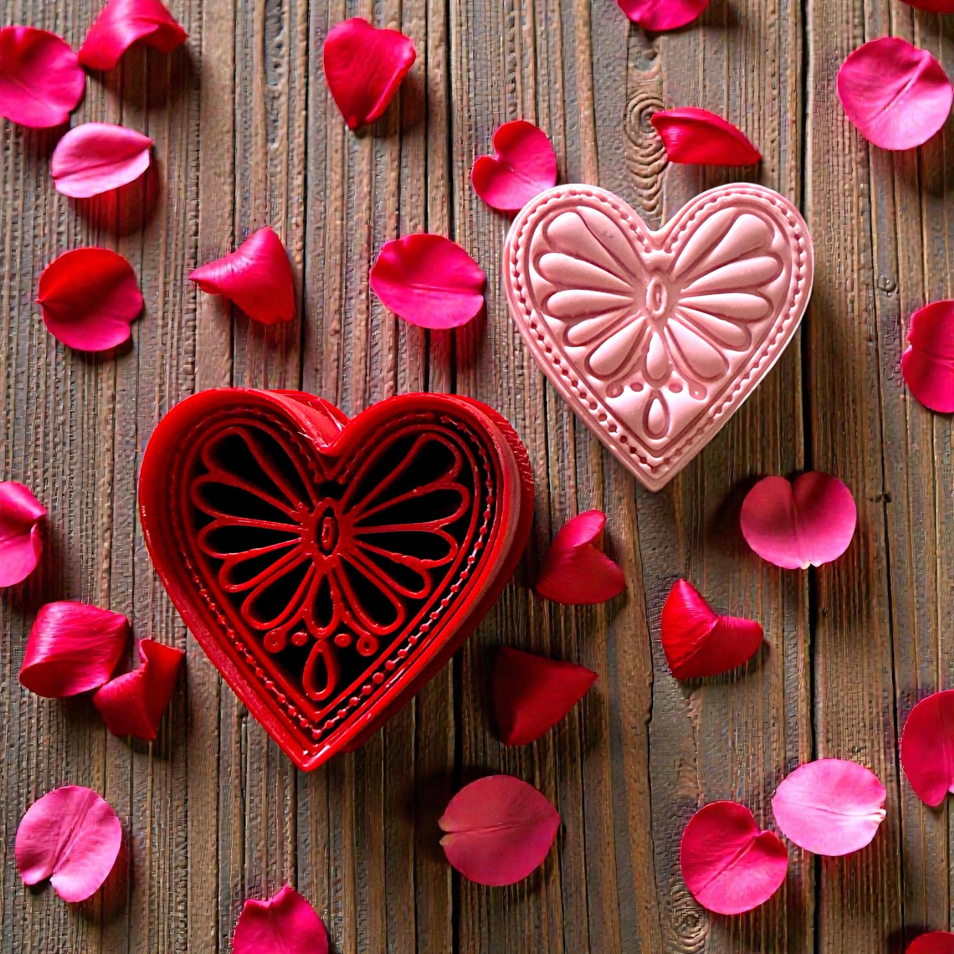 Pink boho heart clay piece with detailed petal design surrounded by rose petals