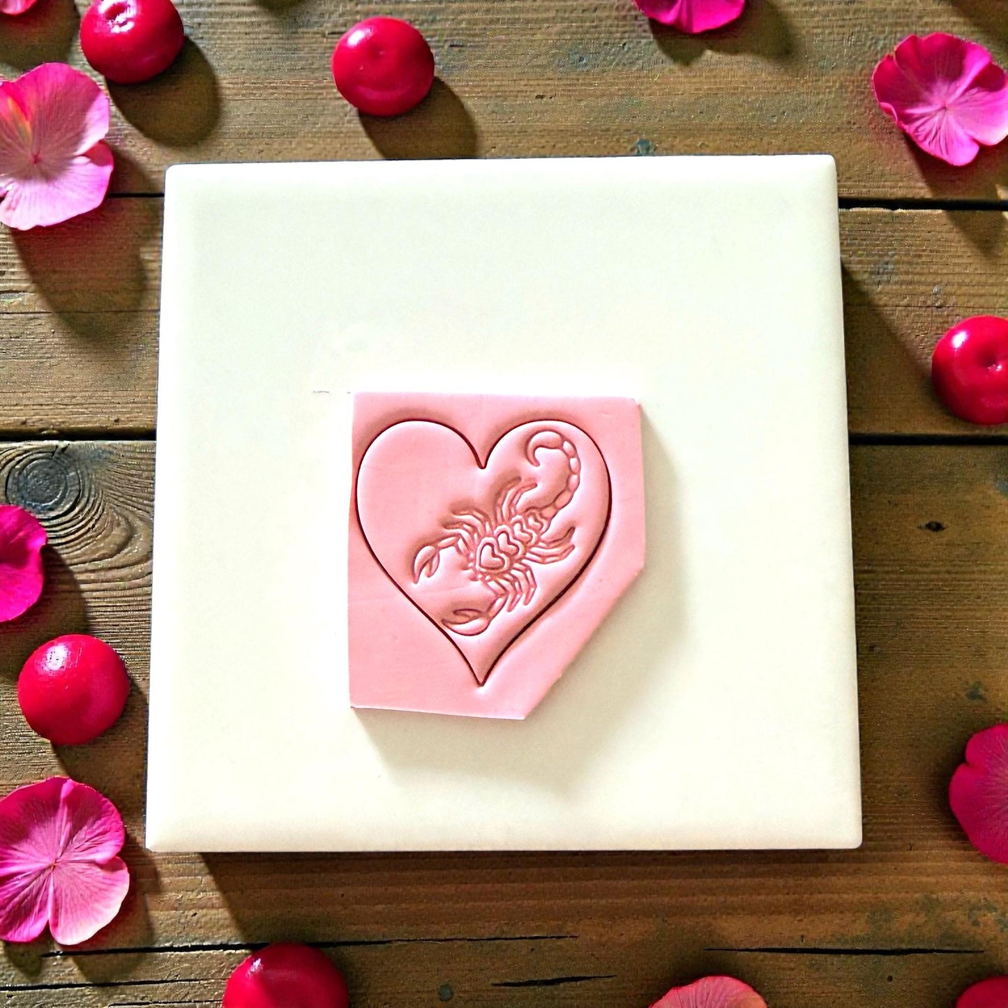 heart scorpion clay imprint on tile